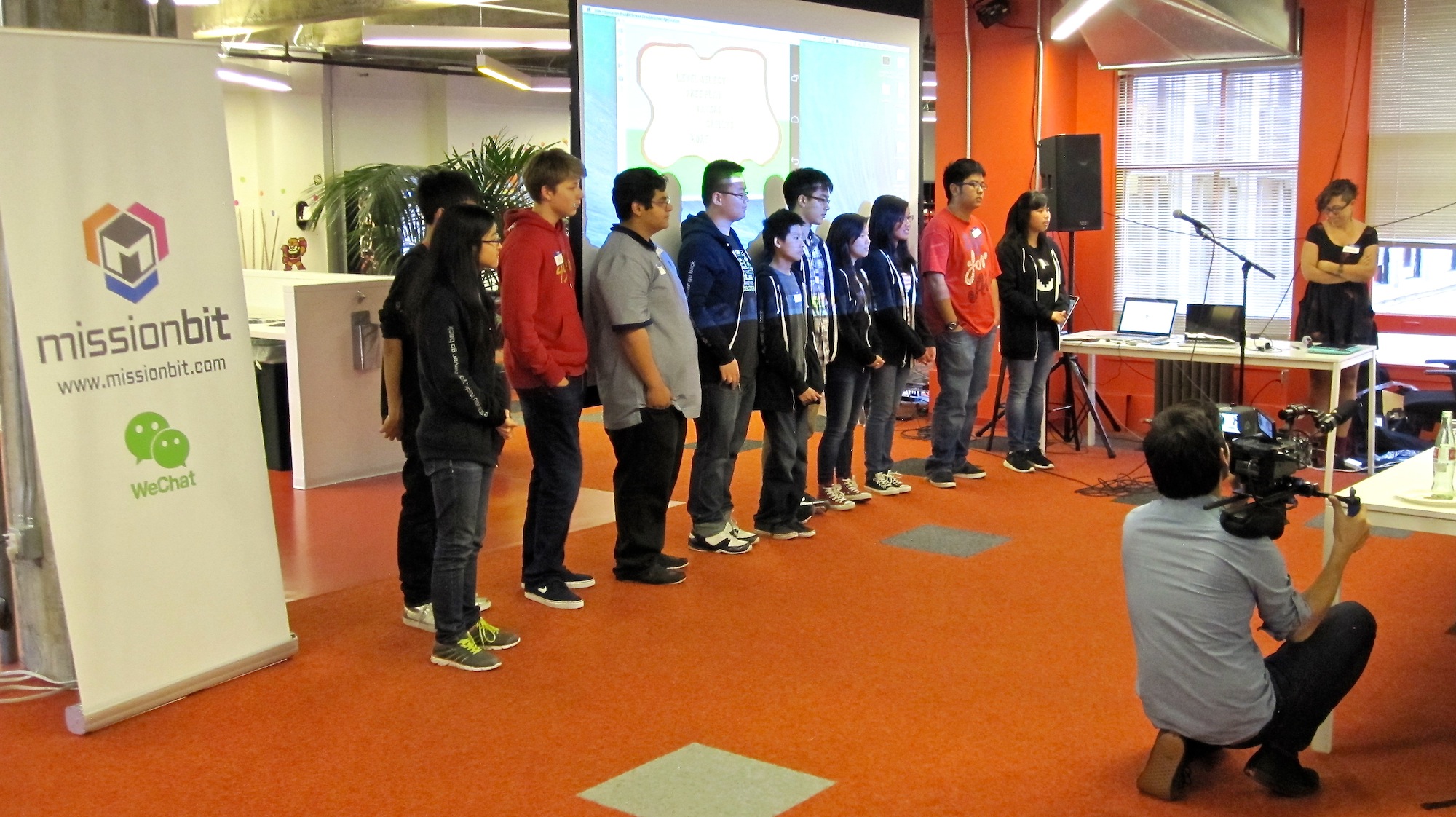 High school students present their final mobile games at Mission Bit's Demo Day.